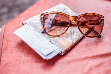 sunglasses and travel map laying in a table © Iweta