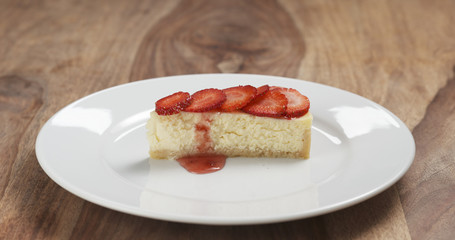 strawberry cheesecake on plate on wood table, 4k photo