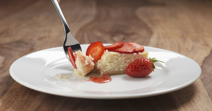 Eating Strawberry Cheesecake With Fork On Wood Table, 4k Photo