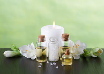 Fototapeta na wymiar Aromatherapy essential oils, candle,flowers and sea salt