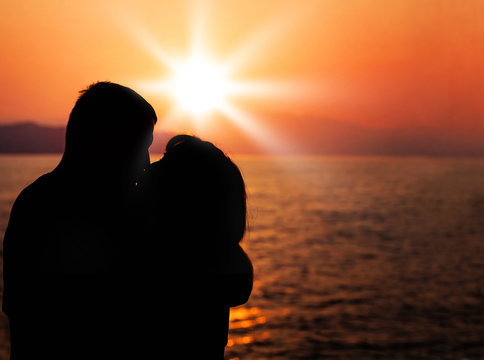 Kissing Couple. Silhouette of Man and Woman in Love during Sunset