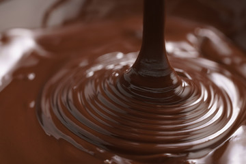 macro photo of premium dark chocolate pour in bowl, shallow focus
