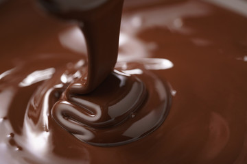 macro photo of premium dark chocolate pour in bowl, shallow focus