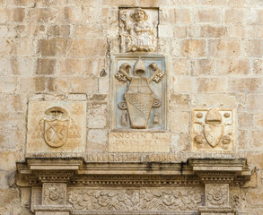 bas-reliefs of stone with Latin inscription surmounting the entrance of the cathedral bisceglie, Puglia. Italy