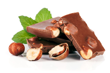 Chocolate with hazelnut and mint leaf isolated on white background