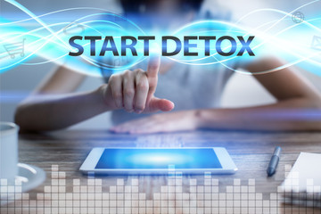 Woman using tablet pc, pressing on virtual screen and selecting start detox.