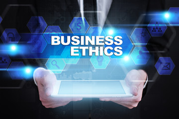 Businessman holding tablet PC with business ethics concept.