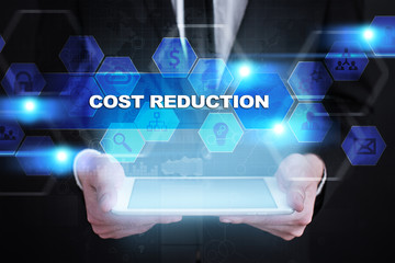 Businessman holding tablet PC with cost reduction concept.