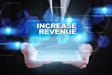 Businessman holding tablet PC with increase revenue concept.