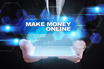 Businessman holding tablet PC with make money online concept.