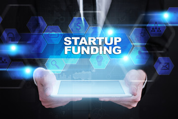 Businessman holding tablet PC with startup funding concept.