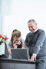 Young woman and elderly man laughing