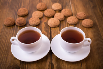 Tea and oaten cookies on a wooden table