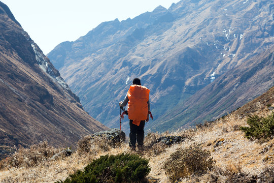 Silhouette of Human with Backpack overlooking Mountain Valley