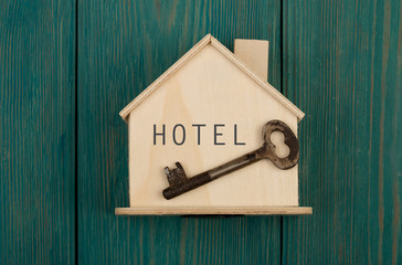 little house with text "HOTEL" and key