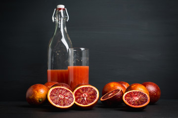 Red Sicilian oranges on the dark wooden background. Shallow depth of field.