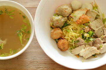 Chinese egg noodles topping shrimp ball and slice boiled pork with soup