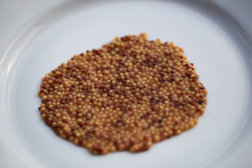 Dry white mustard seeds close-up.