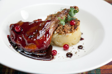 Duck leg Confit with chanterelles, mashed potatoes and raspberry sauce