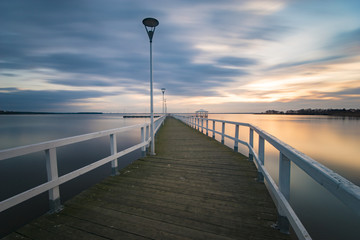 Fototapeta na wymiar wooden pier by the sea, long exposure, evening