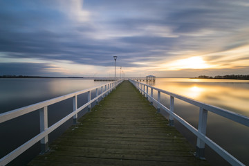 Obraz premium wooden pier by the sea, long exposure, evening