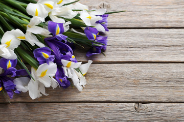 Bouquet of iris flowers on grey wooden table