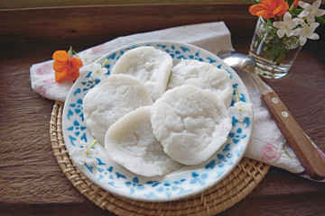 Coconut milk custard on a wood table served by coffee or tea