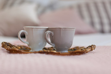 Two cups of coffee on a tray. Breakfast in bed