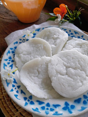 Coconut milk custard on a wood table served by coffee or tea
