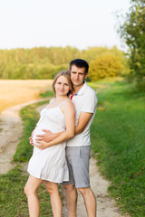 Fototapeta premium Portrait of beautiful young future parents outdoors