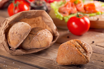 Multigrain bread with slices of smoked salmon, chile pepper and tomatoes