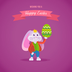 Fototapeta premium Rabbit in clothes, holding an Easter egg in his hand.