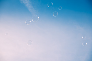 Soap bubbles against the clear blue sky