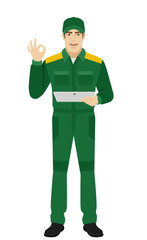 Man in uniform showing a okay hand sign and holding digital tablet PC