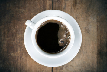 Cup of coffee on the wooden table