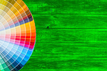 Obraz premium Painter and decorator work table with house project, color swatches, painting roller and paint brushes