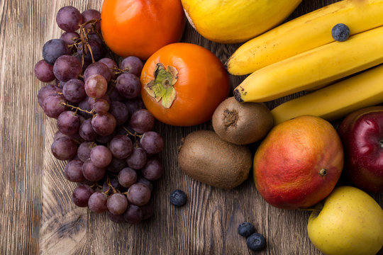 Assorted fruits on wooden backgound
