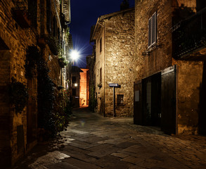 Night view of beautiful Italian medieval Pienza city with lanterns. Travel outdoor Tuscany background.