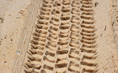 Wheel track in the sand texture. Coast beach sand surface car wheel track on the sand in the natural environment.