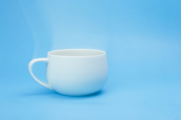 Coffee mug on a blue backdrop.