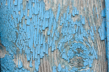 Blue cracked painting on wooden surface