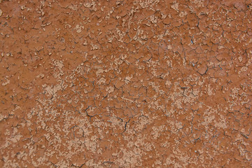 Brown cracked painting on wooden surface