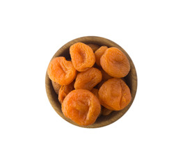 Dried apricots in a wooden bowl. Dried fruit with copy space for text. Top view. Apricots isolated on white background