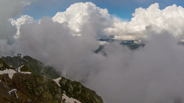 Cableway in the mountains against the clouds sky,timelapse 4K
