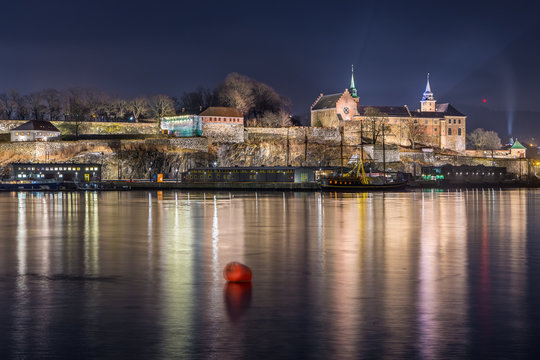 Night view of the Akershus Fortress in Oslo, Norway. View from the Aker Brygge Marina. Oslo, Norway.