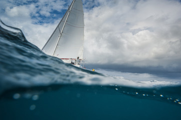 Sailing boat from the underwater view - obrazy, fototapety, plakaty