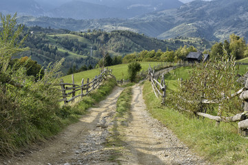 Fototapeta na wymiar September rural scene in Carpathian mountains. Authentic village and fence