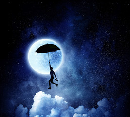 Obraz na płótnie Canvas Woman flying on umbrella . Mixed media