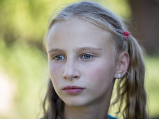 Beautiful young girl outdoors, portrait children close up
