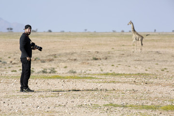 Photographer taking a picture of a giraffe